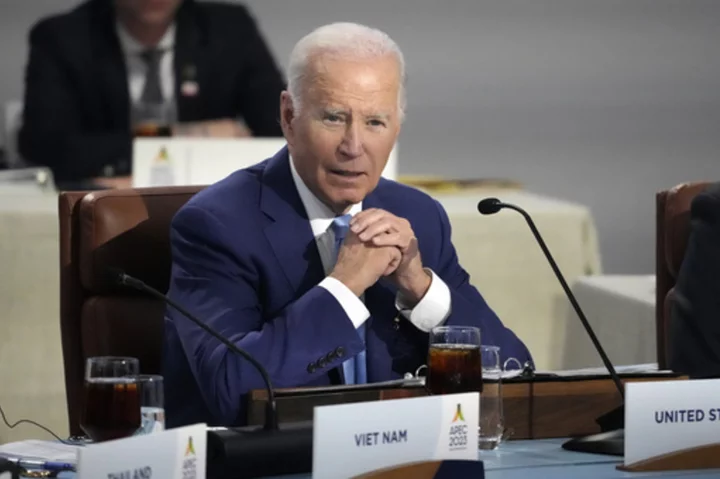 Biden signs temporary spending bill averting government shutdown, pushing budget fight into new year