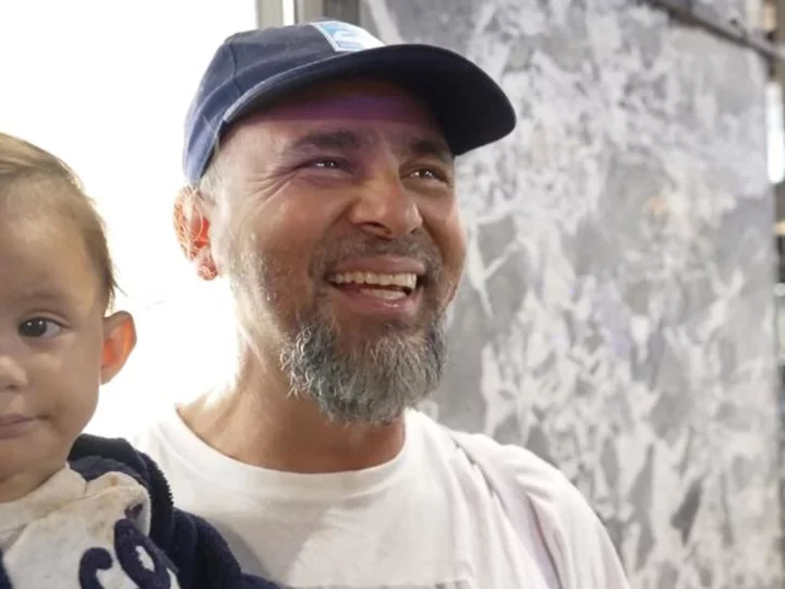 Inside New York's migrant crisis: A father smiles to hold back tears as he looks for help that's costing the city billions