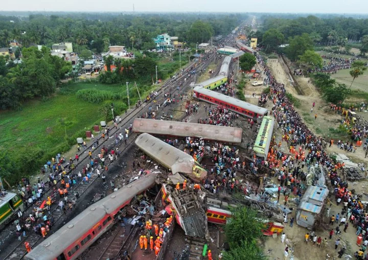 Families, rescuers search for victims of India's worst train crash in decades