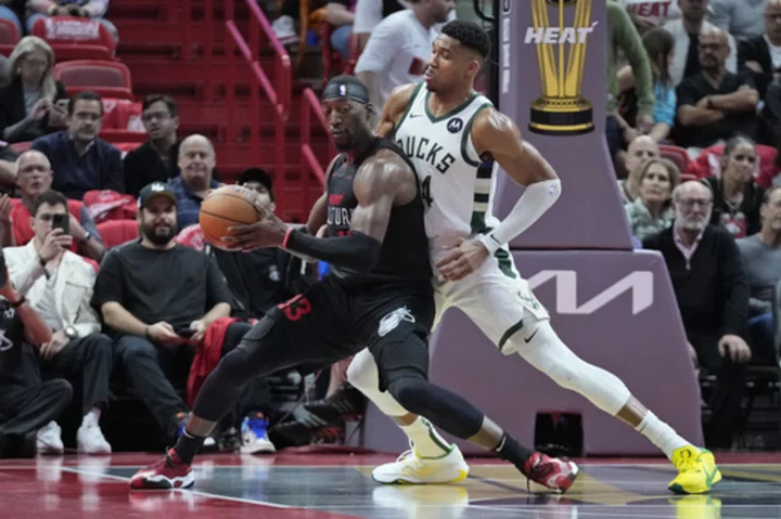 Antetokounmpo, Lillard combine for 65, and Bucks earn quarterfinal berth by topping Heat 131-124