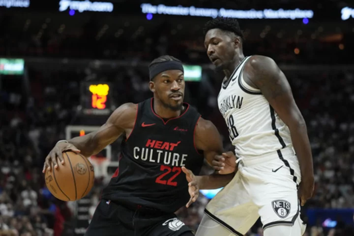 Butler scores 36, Robinson adds 26 and Heat top Nets 122-115 to win 7th straight