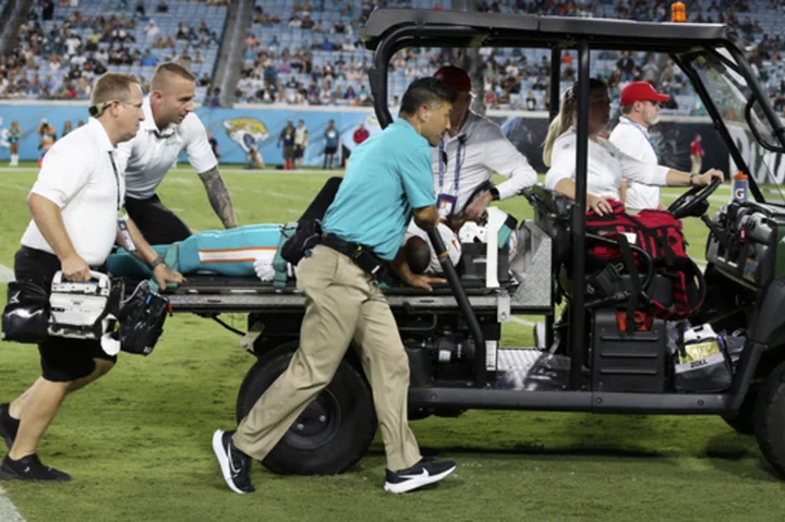 Daewood Davis of Dolphins carted off field after collision; preseason game vs. Jaguars halted