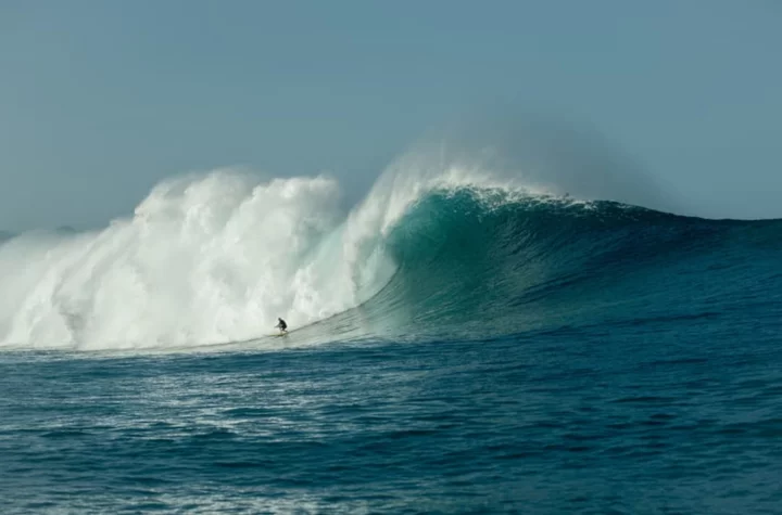 Laura Enever sets a new Guinness World Record for the biggest wave paddled into and surfed by a woman