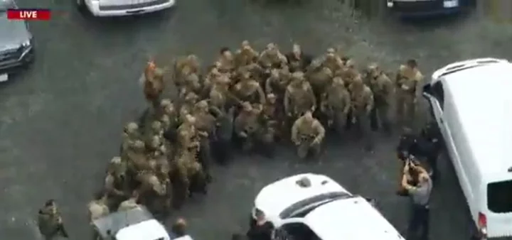 Pennsylvania police pose with captured Danelo Cavalcante after he led them on two-week chase