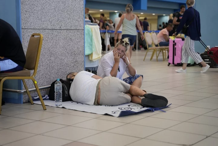 Greece wildfires: Rhodes tourists sleep on airport floor awaiting evacuation